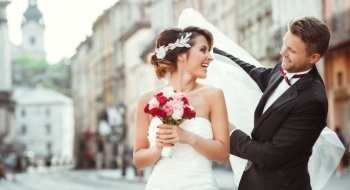 a bride and groom smile at each other