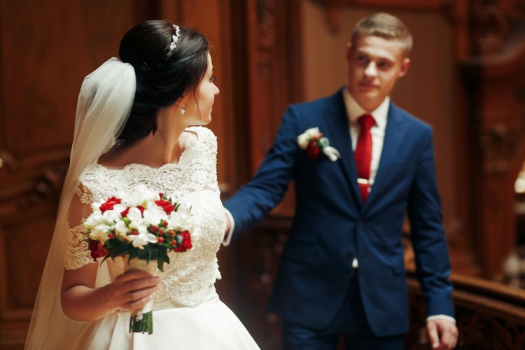 A bride and groom look at each other before the ceremony