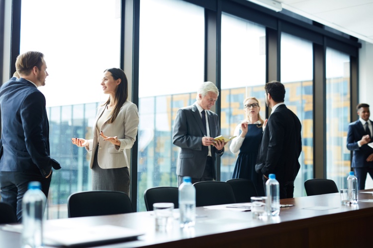 A group of executives meet in a board room
